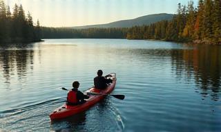 People kayaking in a lake surrounded by mountains